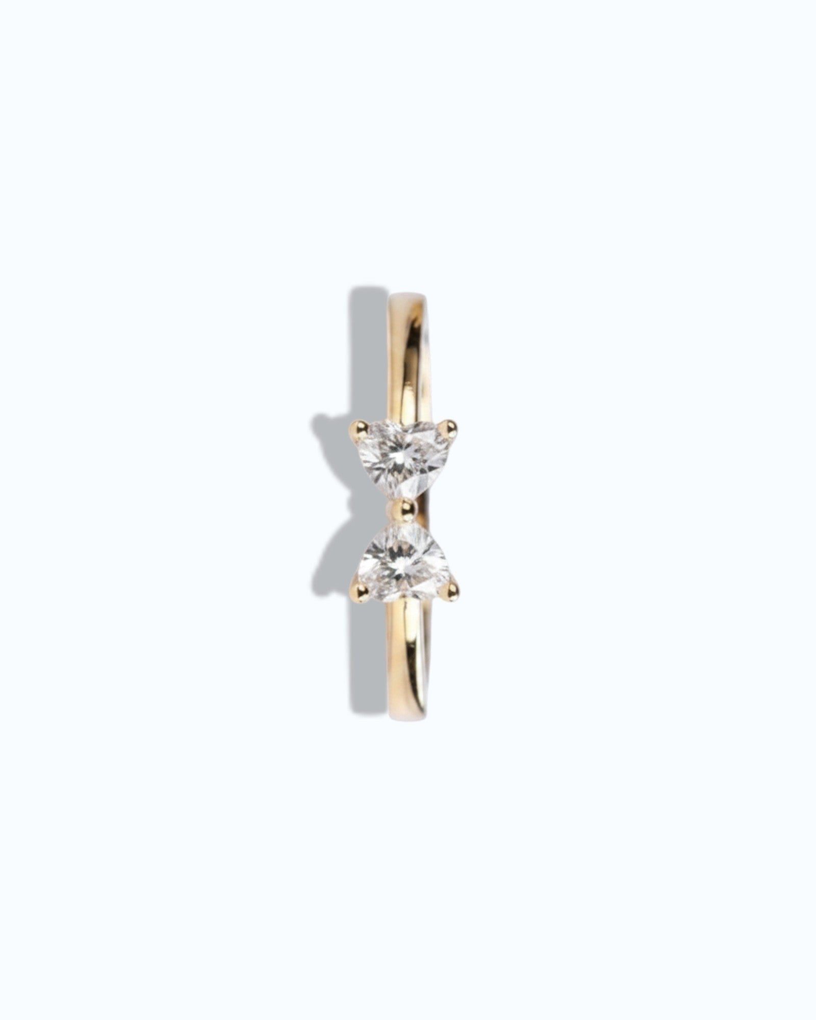 Pearlystones gold ring with two heart-shaped gemstones forming a bow shape.