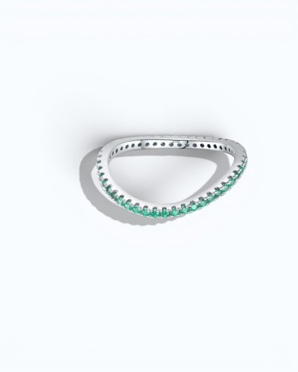 Pearlystones delicate eternity band ring featuring vibrant emerald-green stones set in a polished silver band.
