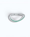 Pearlystones delicate eternity band ring featuring vibrant emerald-green stones set in a polished silver band.