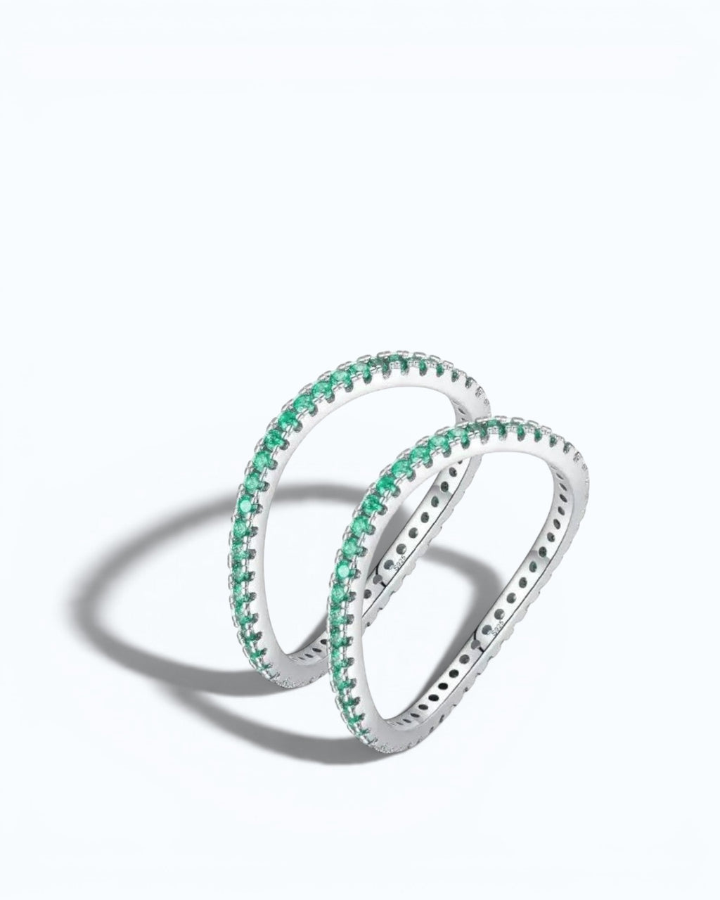 Pearlystones delicate eternity band ring featuring vibrant emerald-green stones set in a polished silver band.