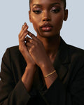 Pearlystones 3mm flat snake chain bracelet in gold, worn by a model.