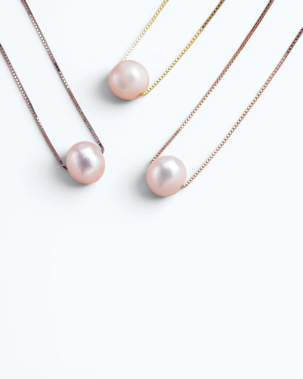 Pearlystones minimalist floating freshwater pearl necklaces in white, yellow, and rose gold sterling silver chains.