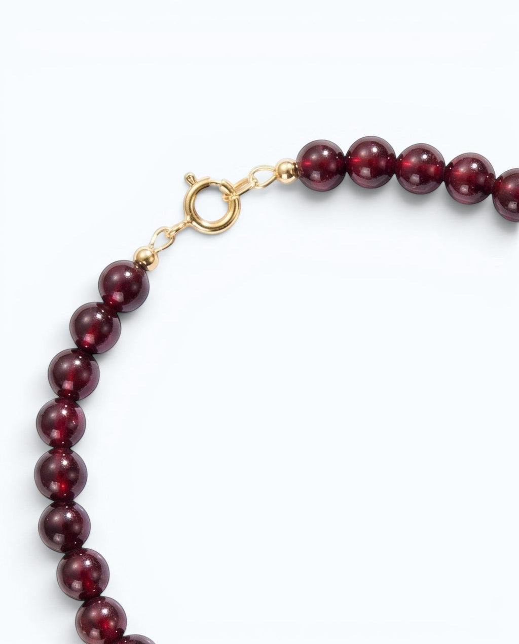 Pearlystones beaded bracelet featuring deep red garnet gemstones, lustrous white pearls, and gold-toned spacers.