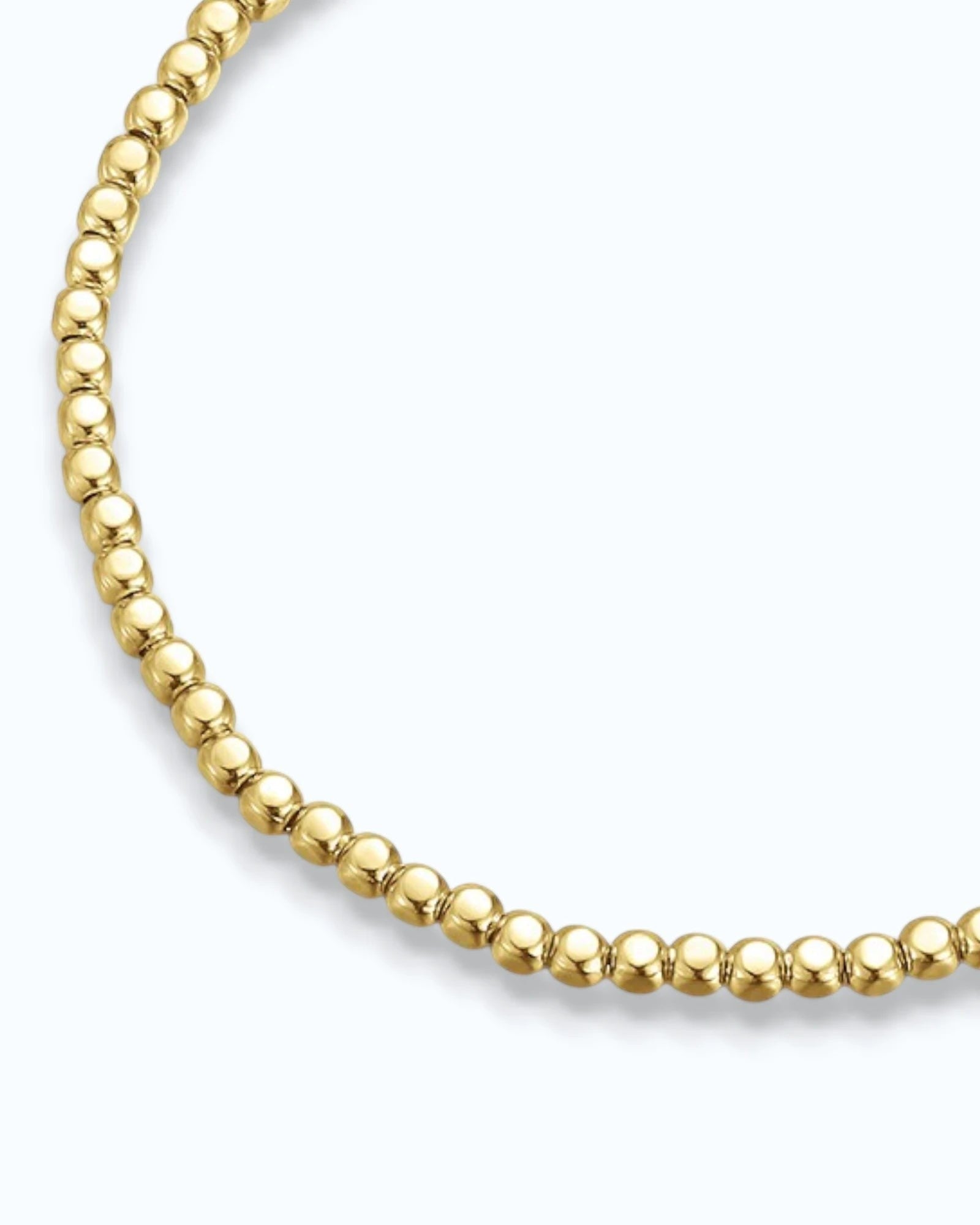 Pearlystones gold-tone beaded chain bracelet with uniformly sized polished beads on a flexible chain.