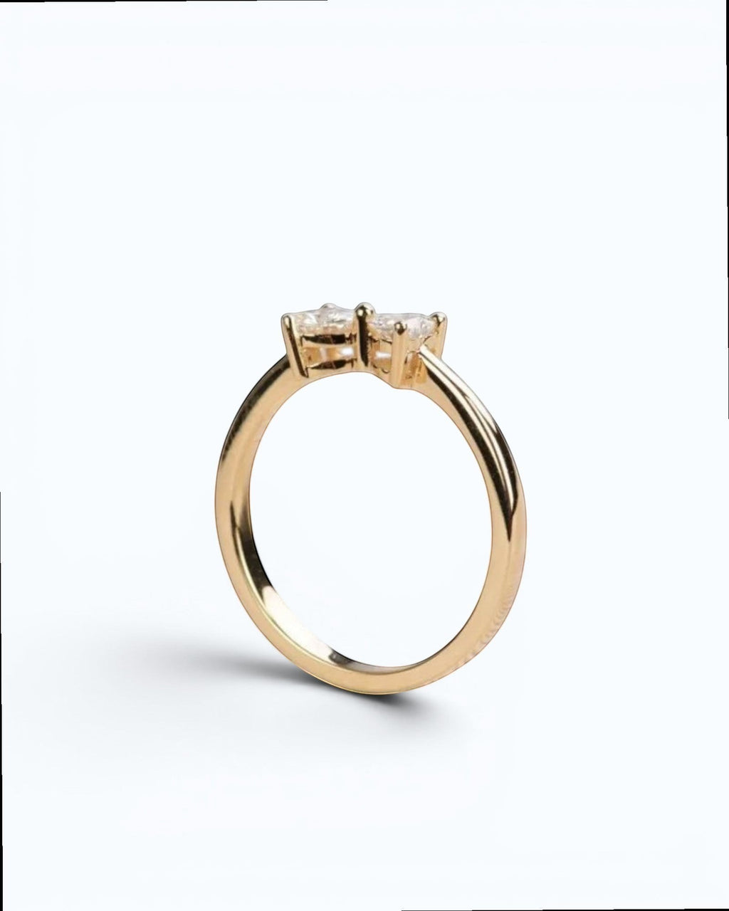 Pearlystones gold ring with two heart-shaped gemstones forming a bow design.
