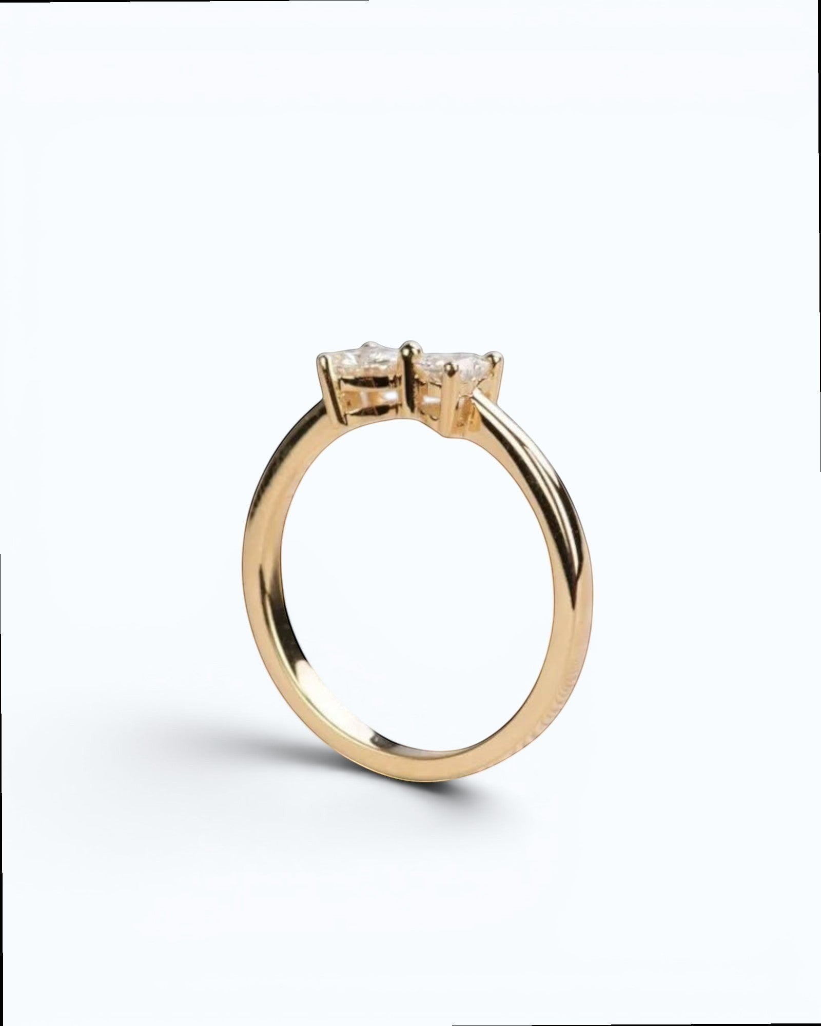 Pearlystones gold ring with two heart-shaped gemstones forming a bow design.