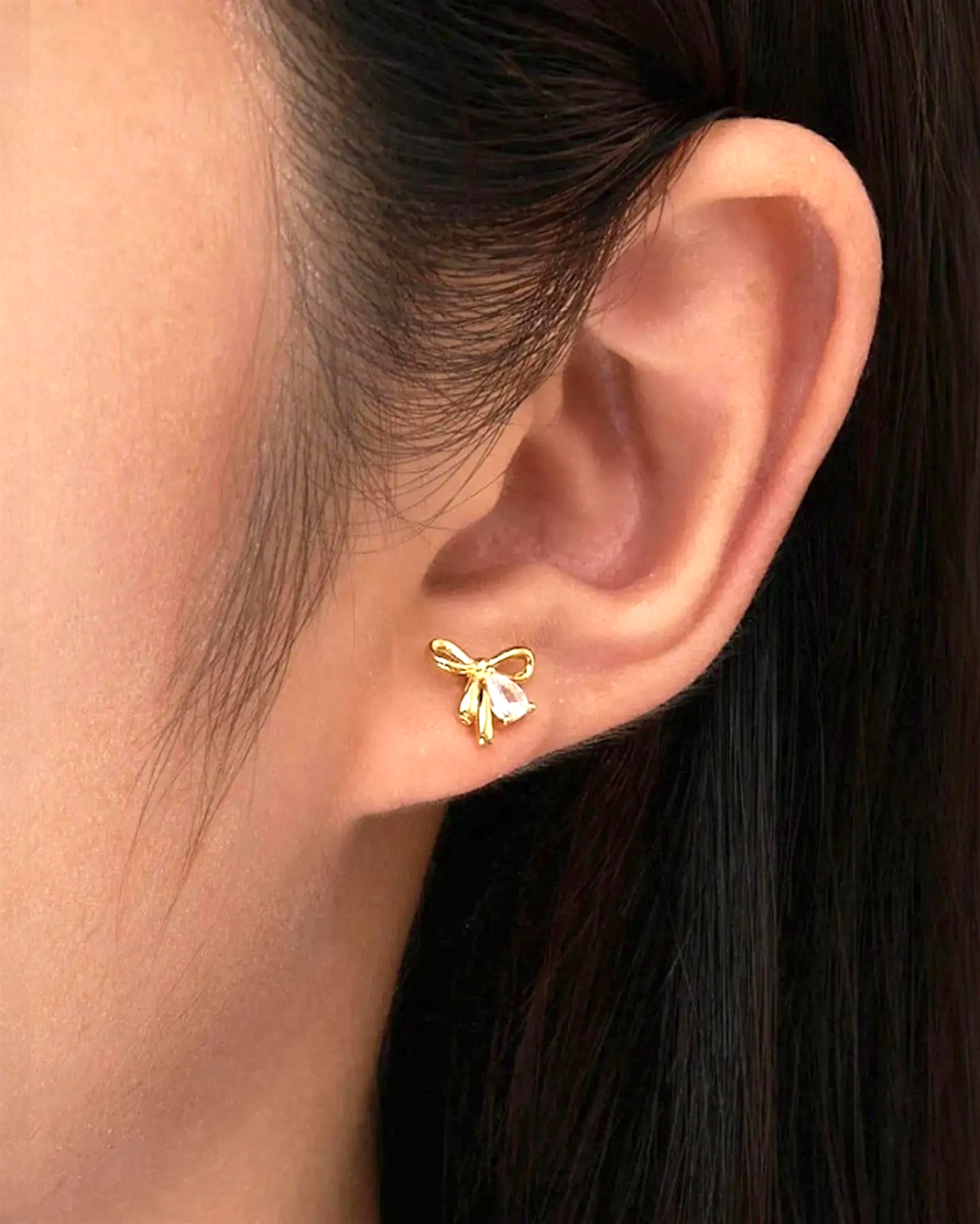 Pearlystones gold plated bowknot stud earrings with clear zirconia accent, perfect for everyday wear.