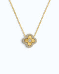 Pearlystones gold clover pendant necklace with laser-engraved sunburst rays, central zircon, and pavé zircon halo.