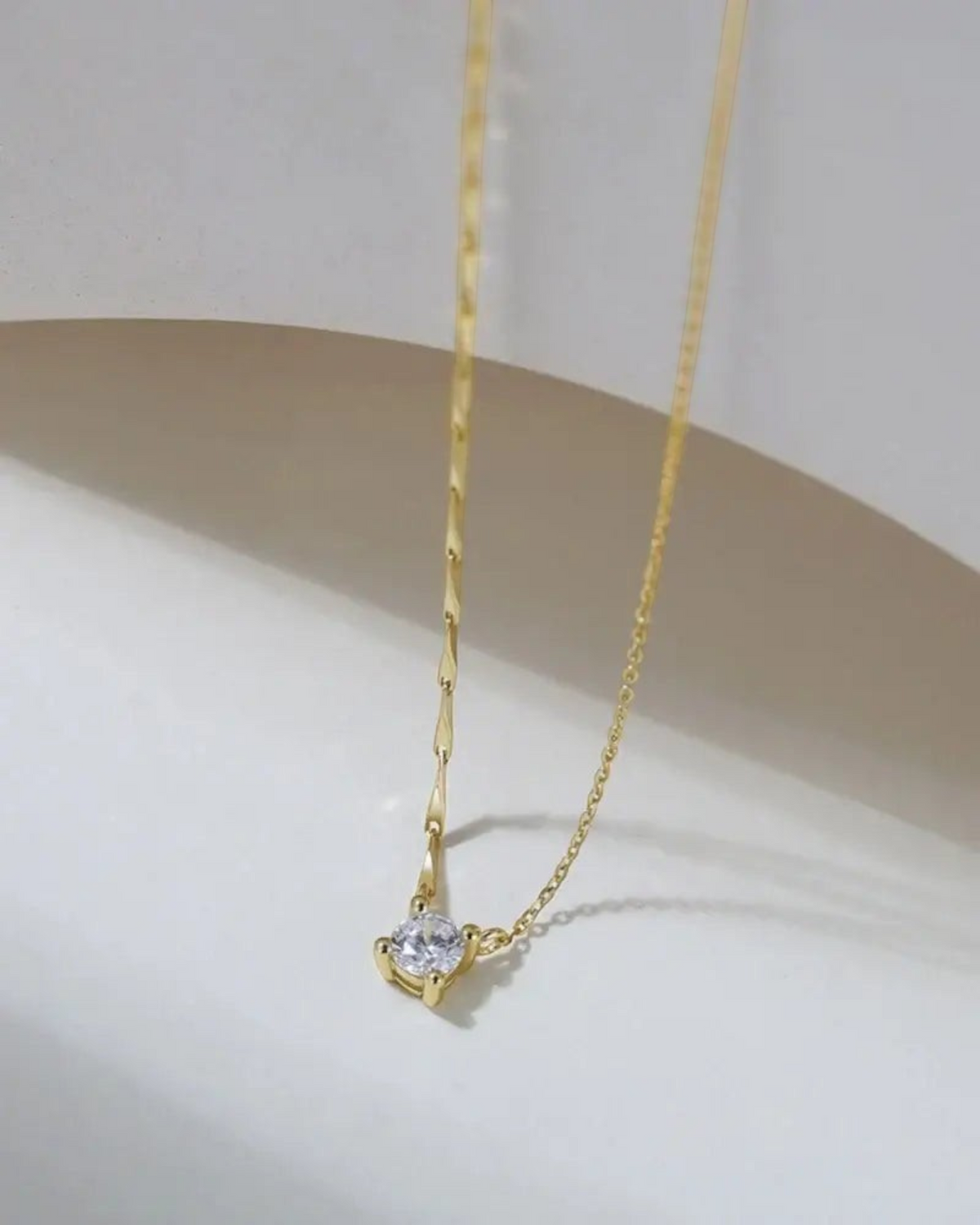 Pearlystones gold-plated sterling silver necklace featuring a brilliant-cut cubic zirconia pendant on a dapped chain.