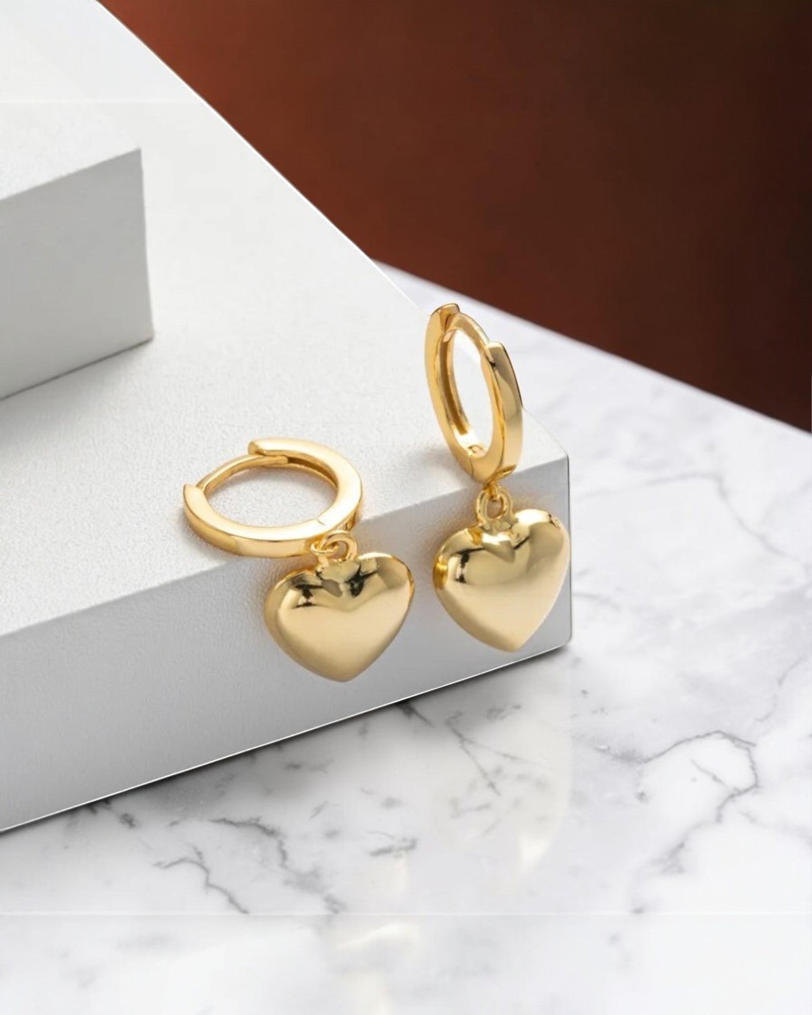 Pearlystones gold heart charm hoop earrings, crafted from sterling silver with a puffed heart charm.