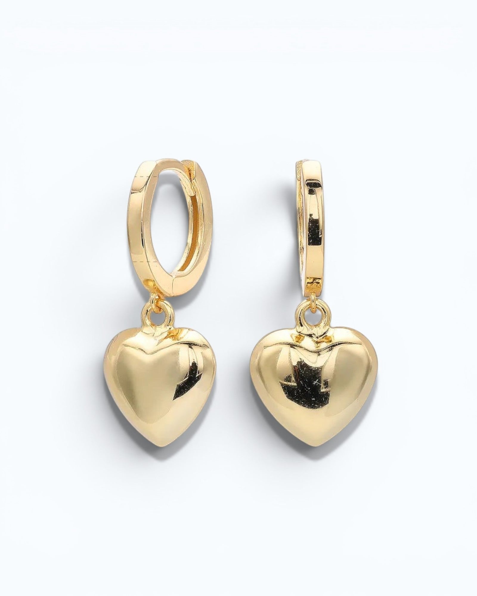 Pearlystones gold heart charm hoop earrings crafted from sterling silver with a puffed heart pendant.
