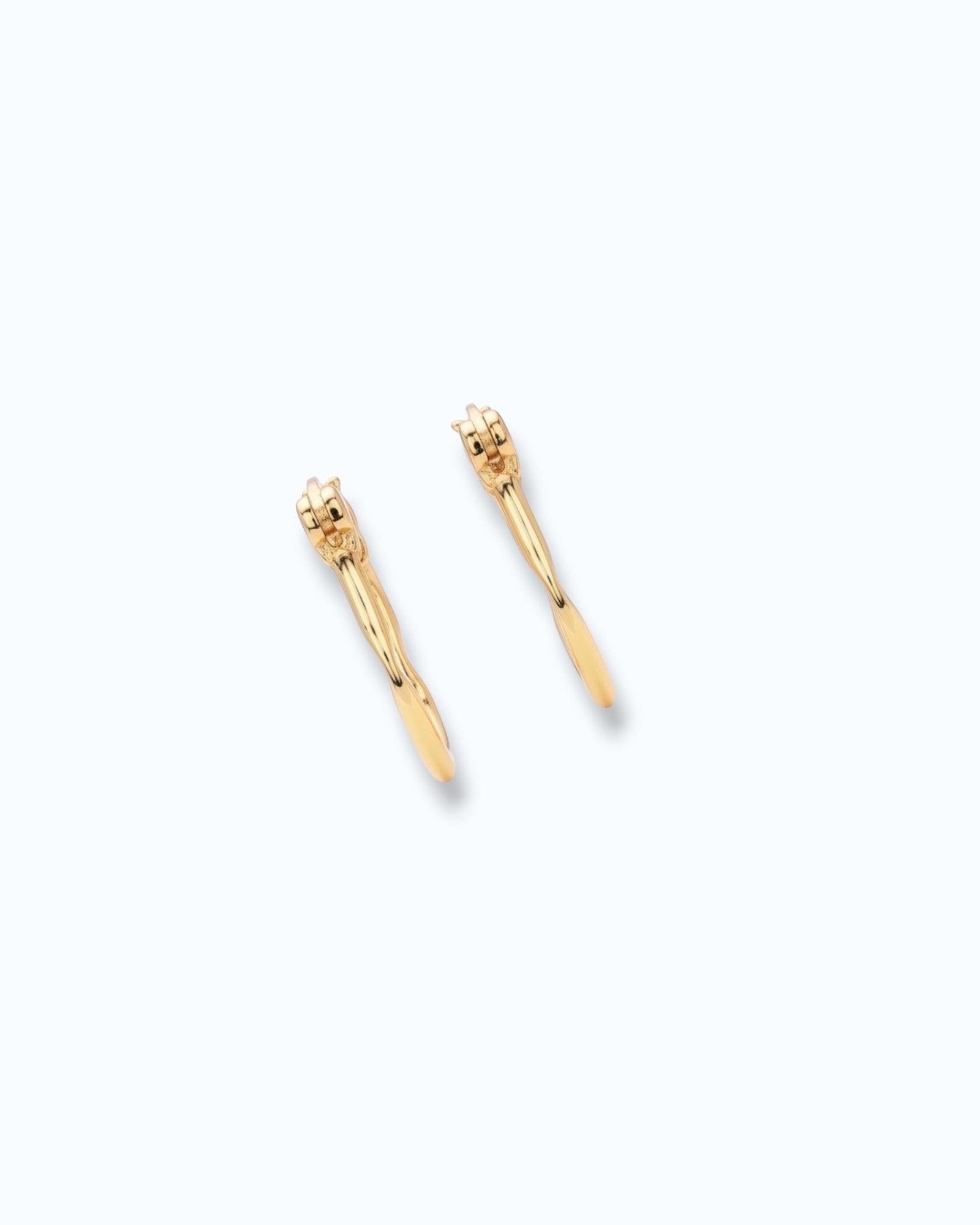 Pearlstones gold molten texture medium hoop earrings with hinged creole closure.