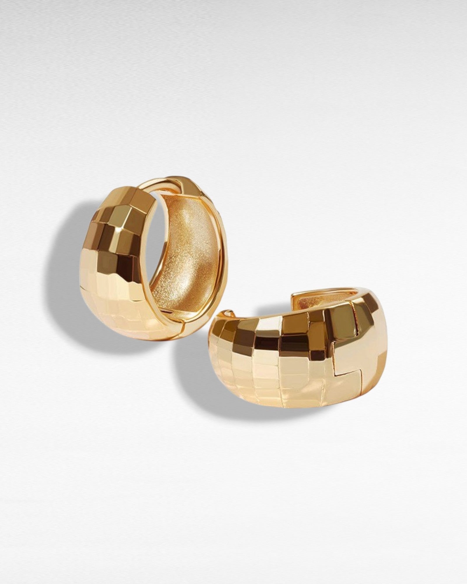 Pearlystones gold-tone sterling silver huggie hoop earrings with geometric texture. Perfect for everyday wear.