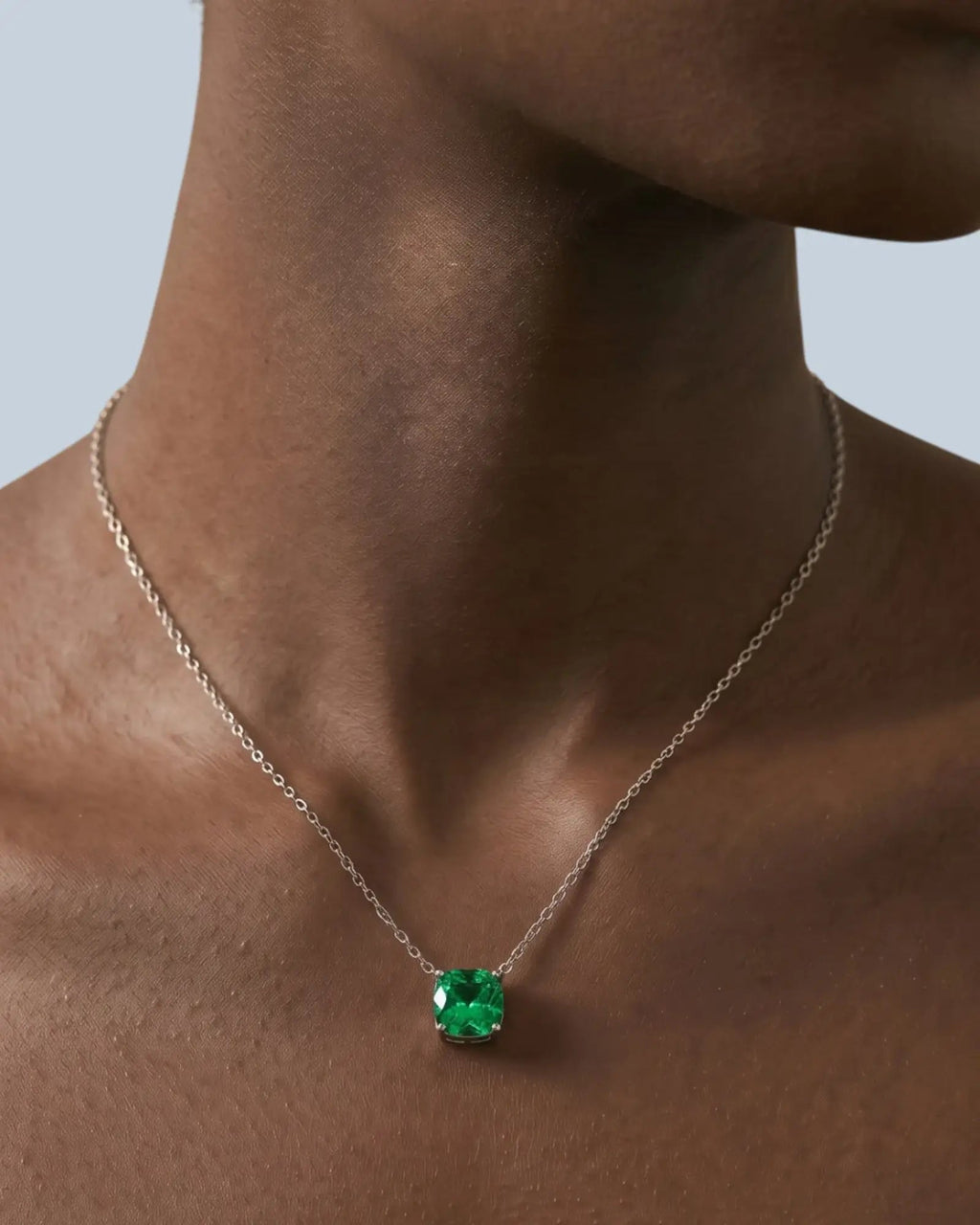 Pearlystones octagonal rose cut green cubic zirconia pendant necklace on a silver chain worn around a model's neck.