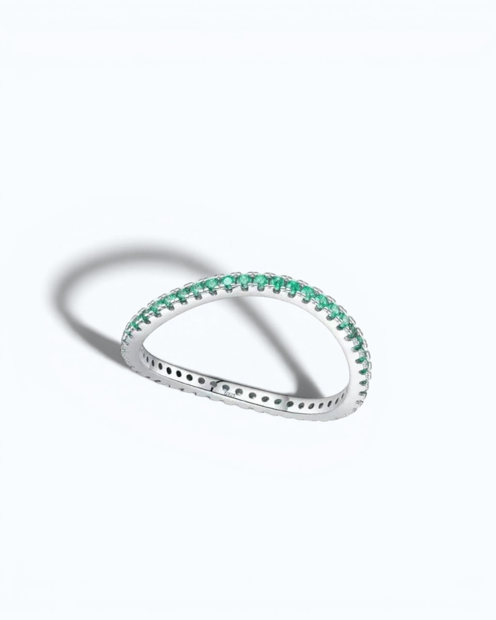 Pearlystones delicate eternity band ring featuring vibrant emerald-green stones set in a polished silver band.