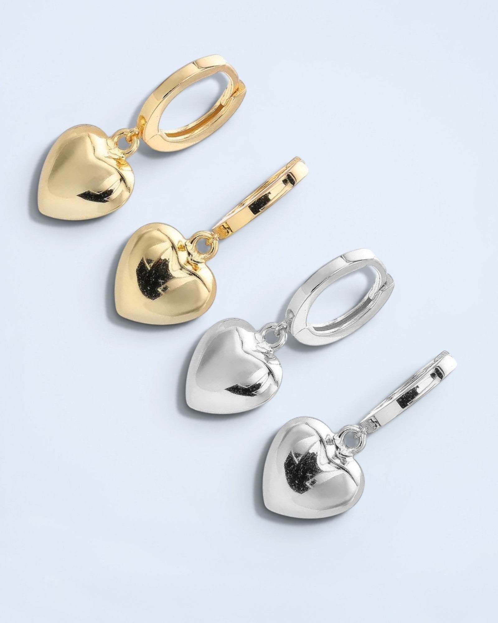 Pearlystones gold and silver heart charm hoop earrings. Classic hoops with puffed heart charms.
