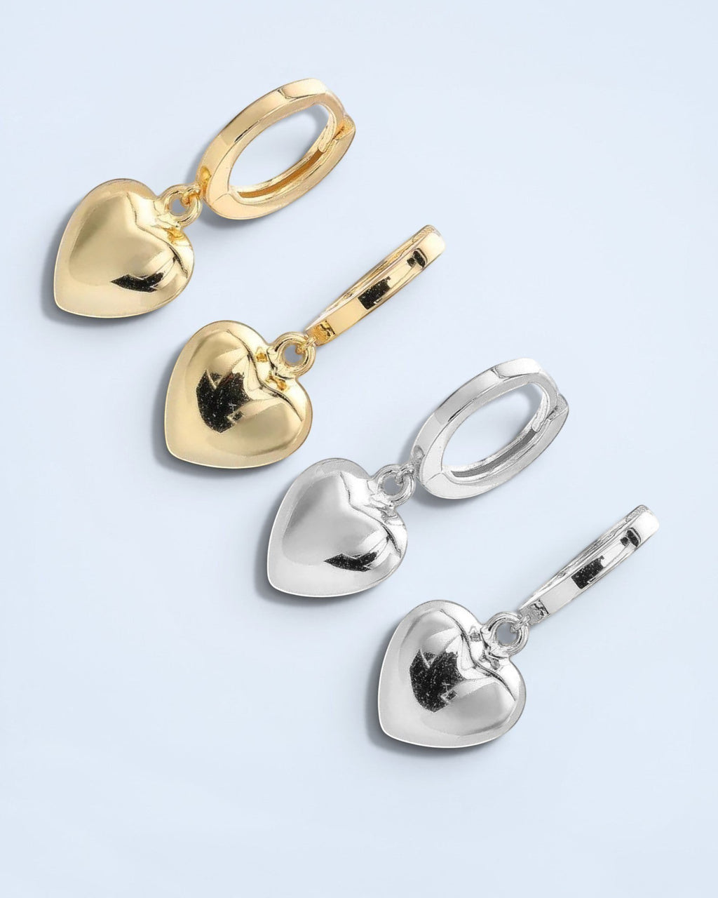 Pearlystones gold and silver heart charm hoop earrings. Classic hoops with puffed heart charms.