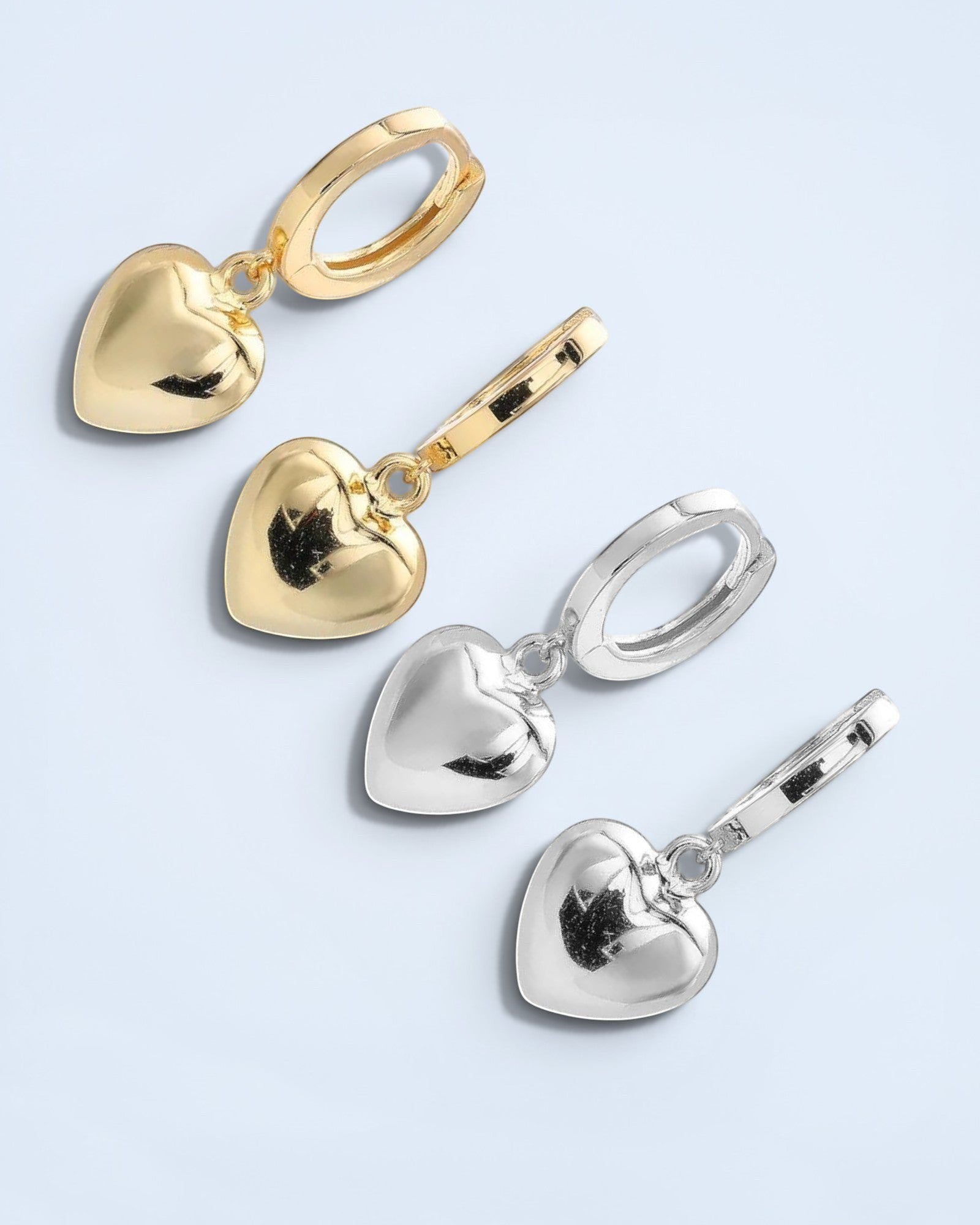 Pearlystones gold and silver heart charm hoop earrings. Classic hoops with puffed heart charms.