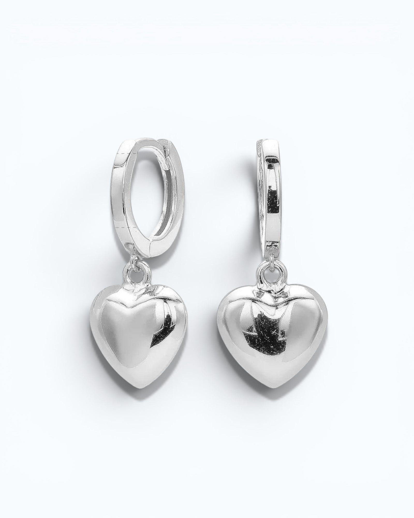 Pearlystones silver sterling heart charm hoop earrings. Classic hoop with a puffed heart charm.