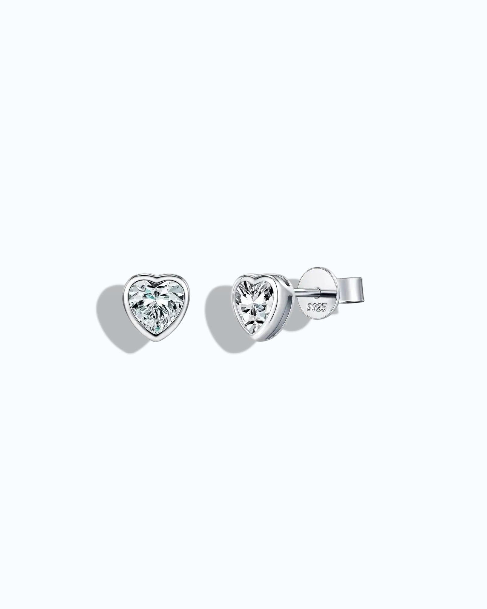 Pearlystones 5mm heart-shaped moissanite stud earrings in rhodium-plated sterling silver with a clean bezel setting.