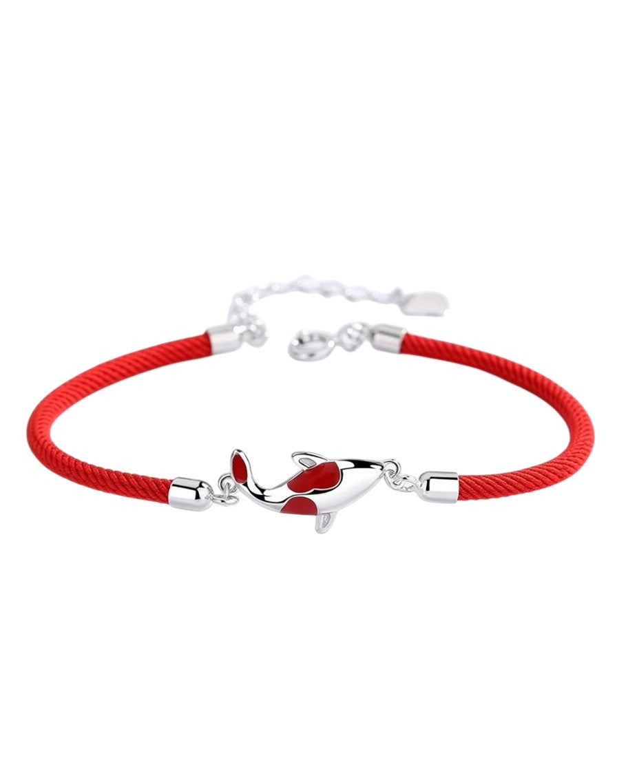 Pearlystones koi fish charm bracelet featuring a vibrant red cord and a polished silver koi accent with red enamel.