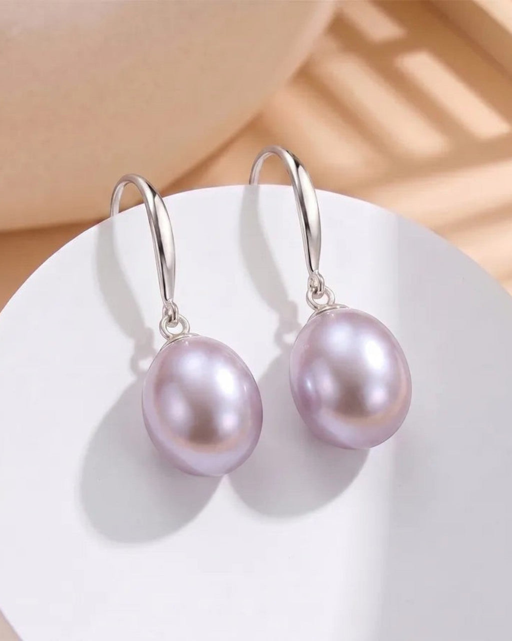 Pearlystones Classic Purple Pearl Drop Earrings with silver-tone hooks. Lustrous pearls in a delicate purple hue.