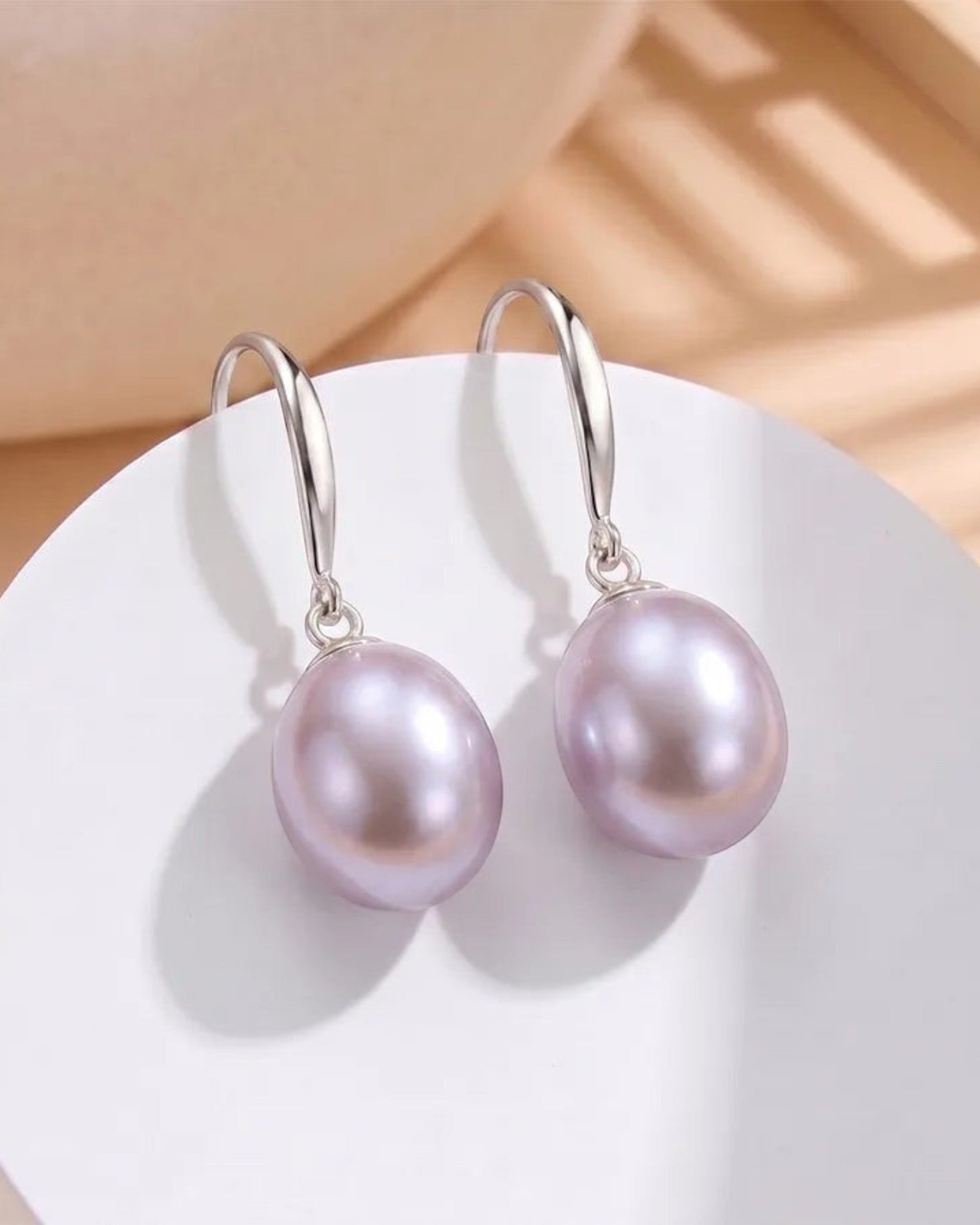 Pearlystones Classic Purple Pearl Drop Earrings with silver-tone hooks. Lustrous pearls in a delicate purple hue.
