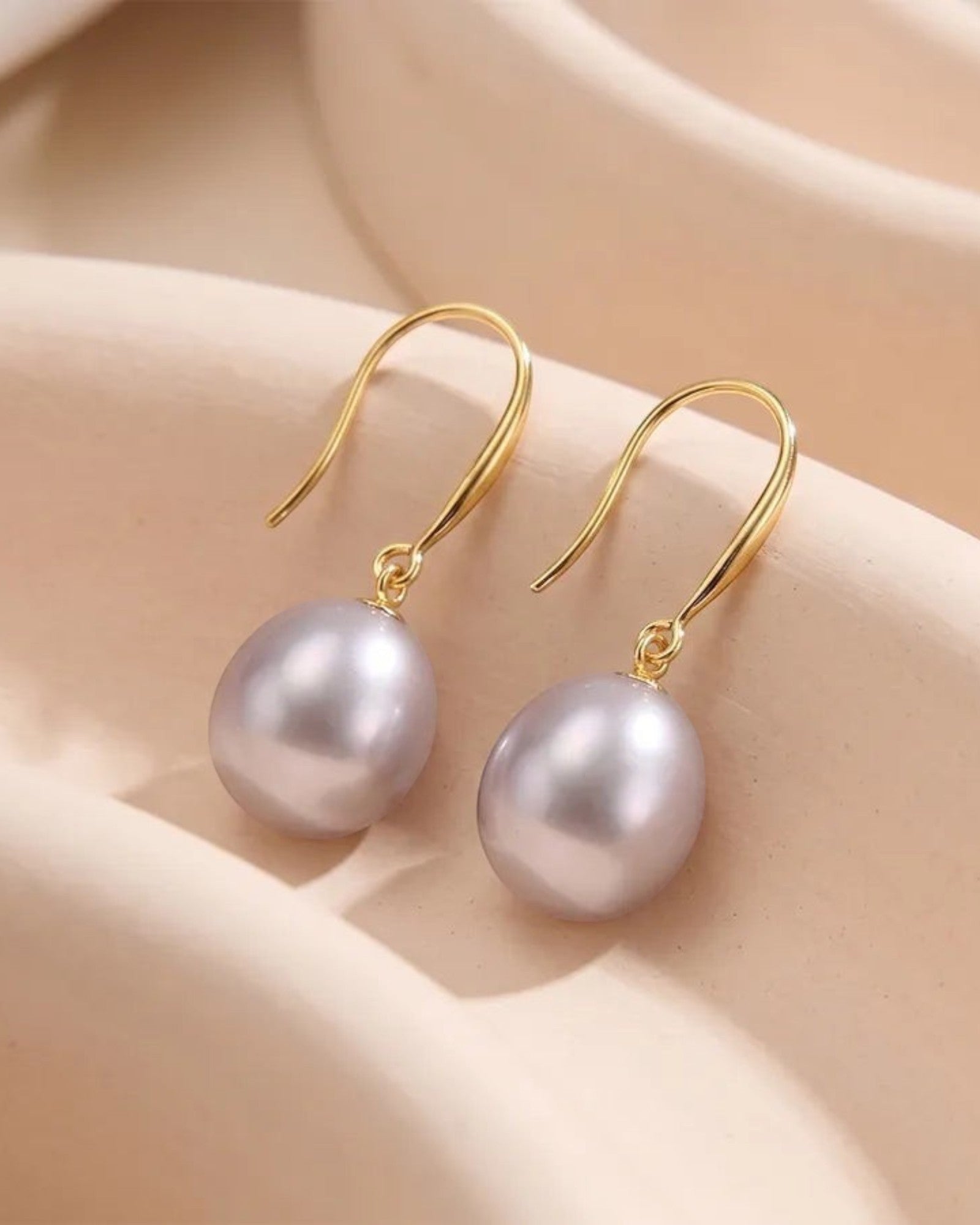 Pearlystones Classic Purple Pearl Drop Earrings with gold-tone hooks. Lustrous pearls in a delicate purple hue.