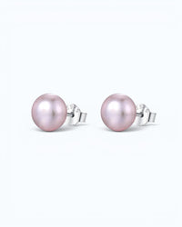Pearlystones classic round purple pearl stud earrings with silver posts on a clean white background.