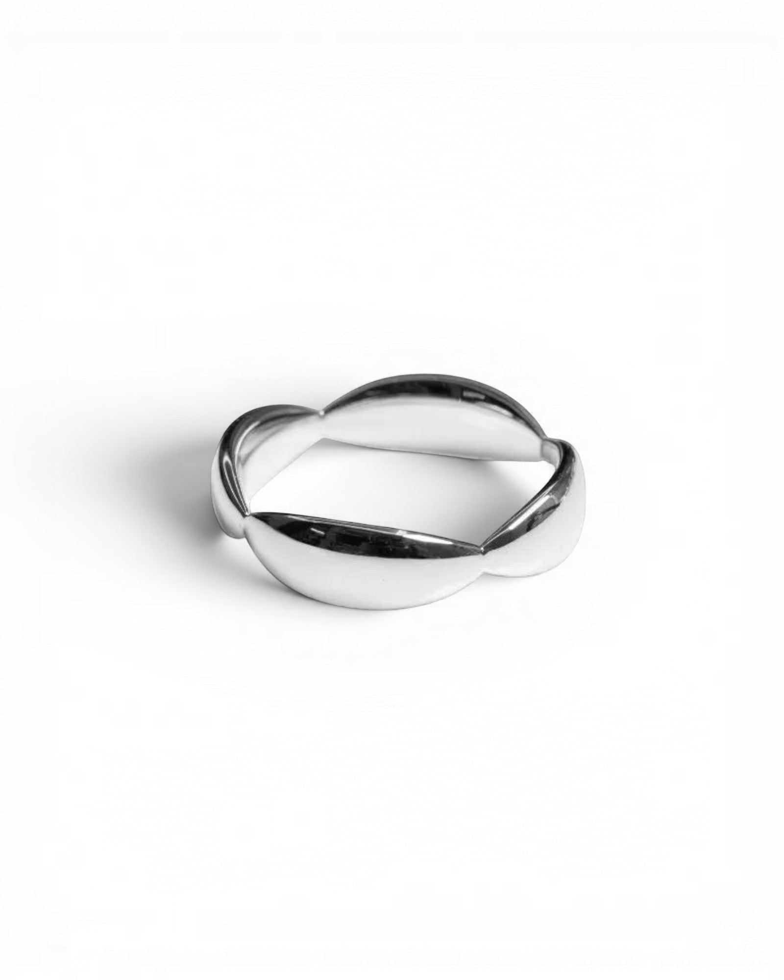 Pearlystones Sculptural Wave Band Ring in polished silver metal, featuring an undulating design.