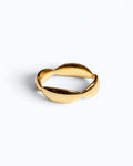 Pearlystones Sculptural Wave Band Ring in polished gold metal with a lustrous finish.