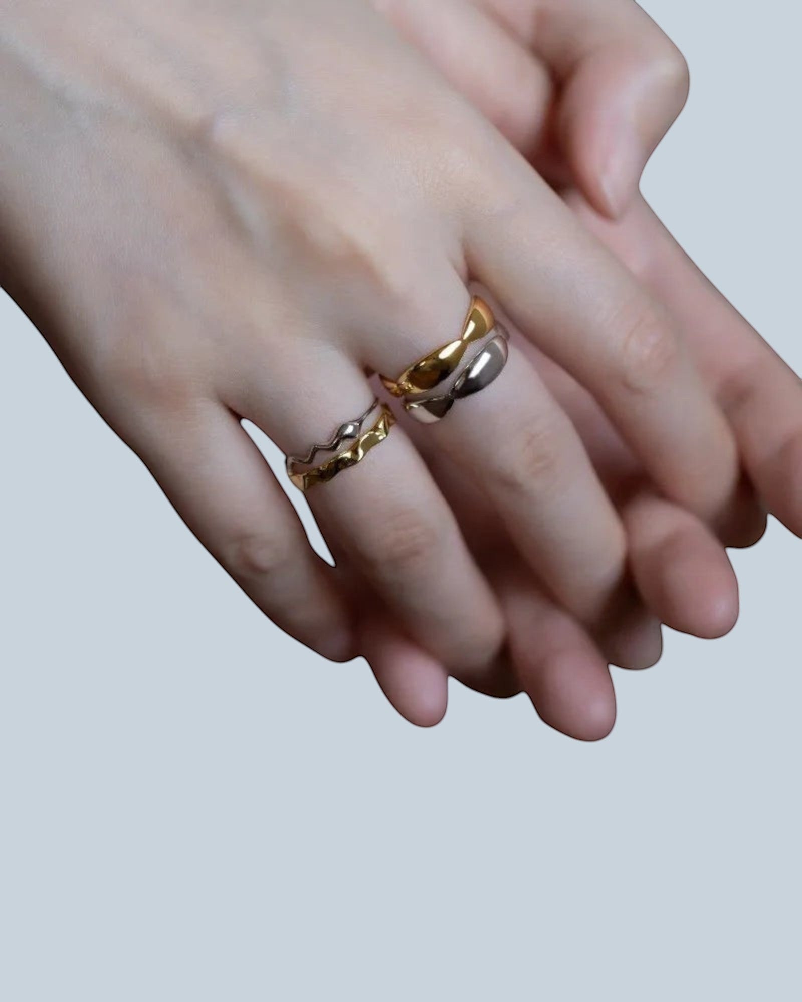 Pearlystones Sculptural Wave Band Ring in polished gold and silver tones, featuring an undulating design.