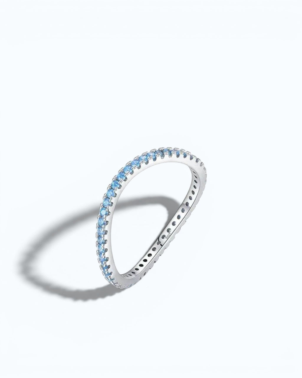 Pearlystones Azure Glow eternity band in sterling silver featuring a row of vibrant blue zircon stones.