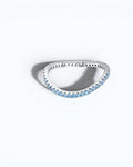 Pearlystones Azure Glow eternity band in sterling silver featuring a row of vibrant blue zircon stones.