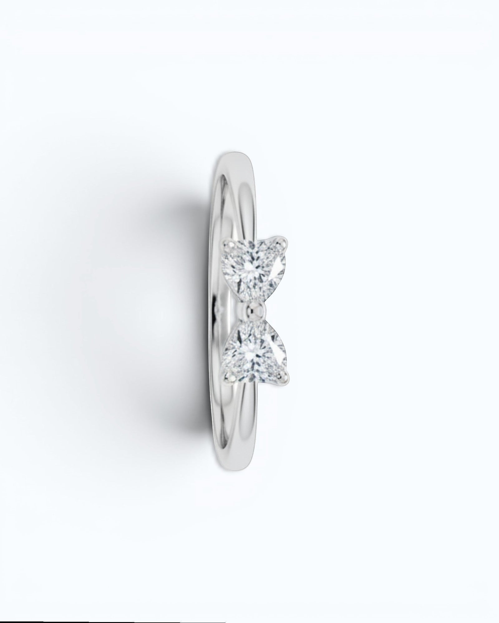 Pearlystones silver ring with a bow design adorned with two heart-shaped gemstones.
