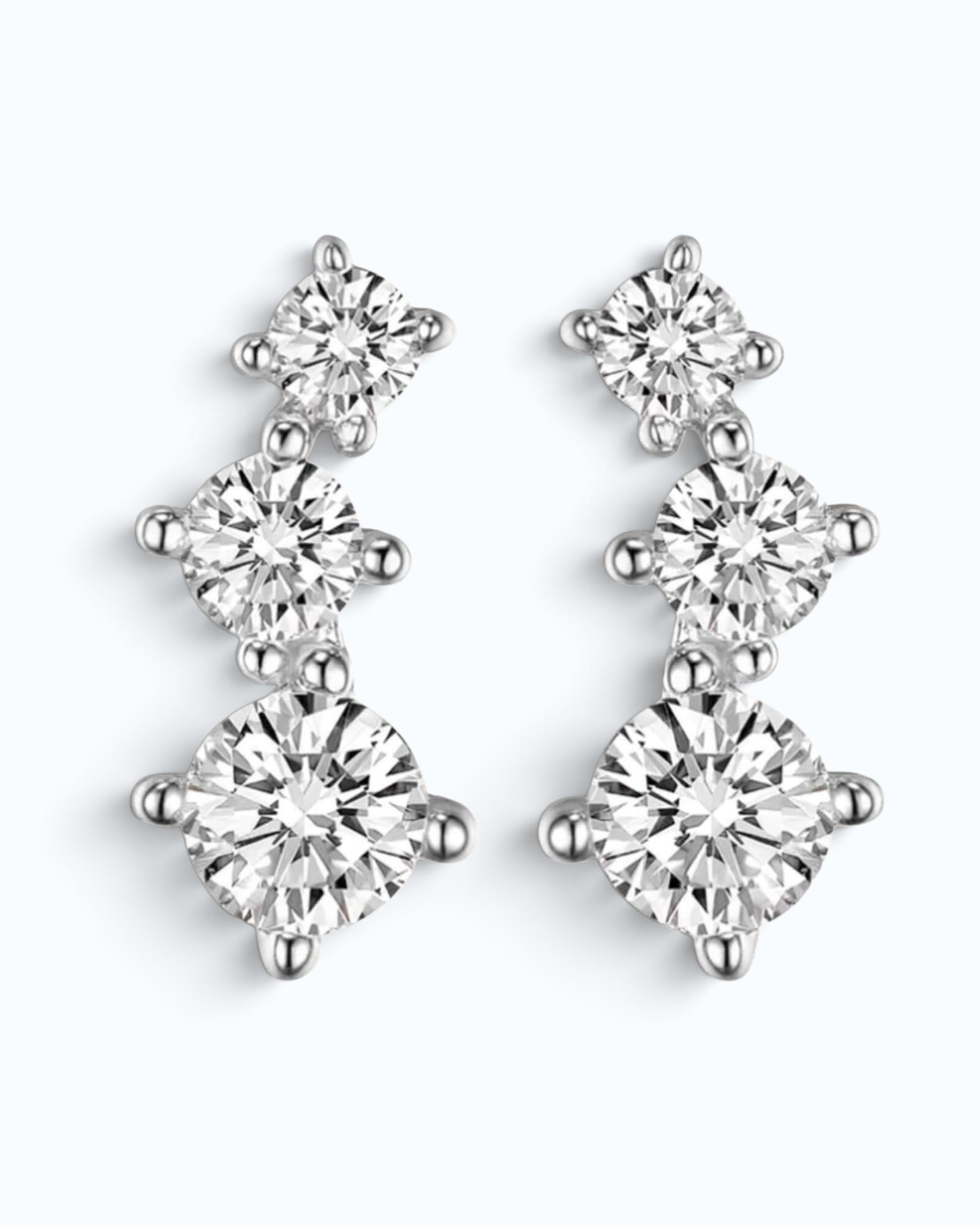 Pearlystones silver rhombus stud earrings featuring three sparkling AAAAA-grade zirconia stones in a delicate drop design.