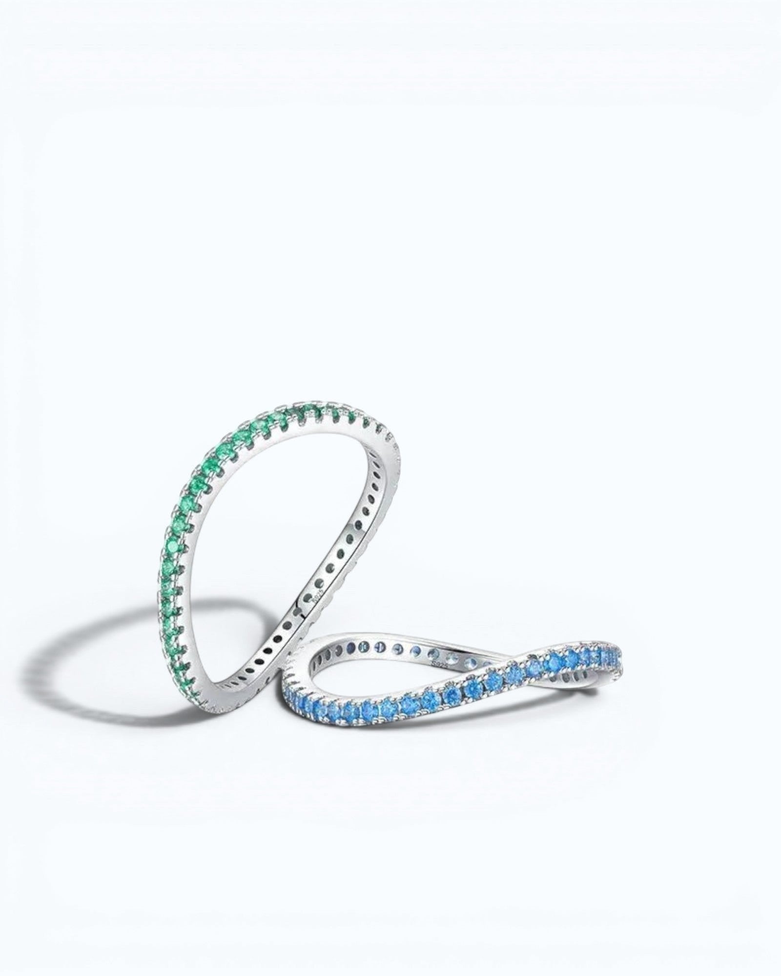 Pearlystones sterling silver eternity bands featuring vibrant blue and green zircon stones in a slim, stackable design.