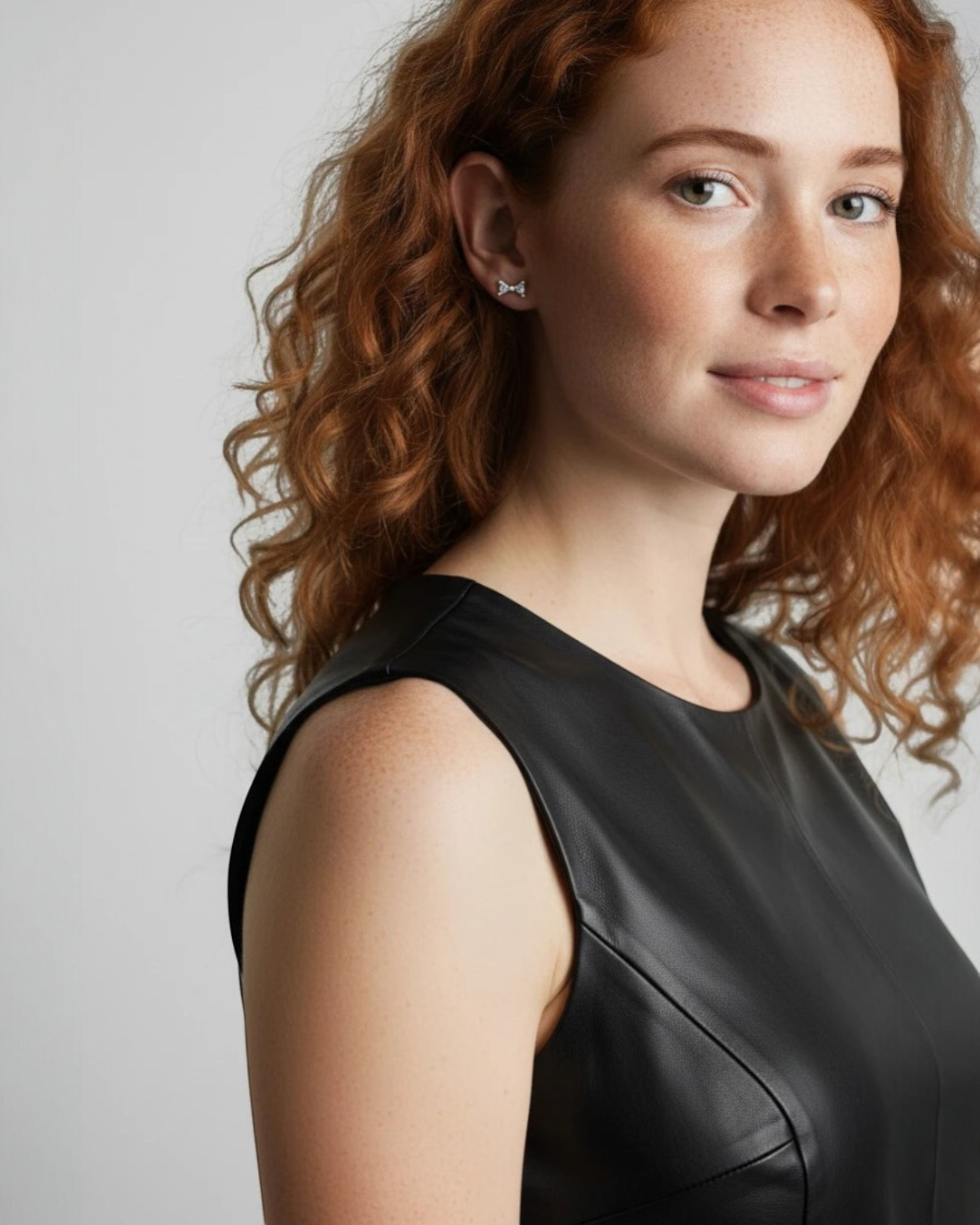 Pearlystones small sterling silver bow stud earrings with white gold plating. Delicate and elegant.