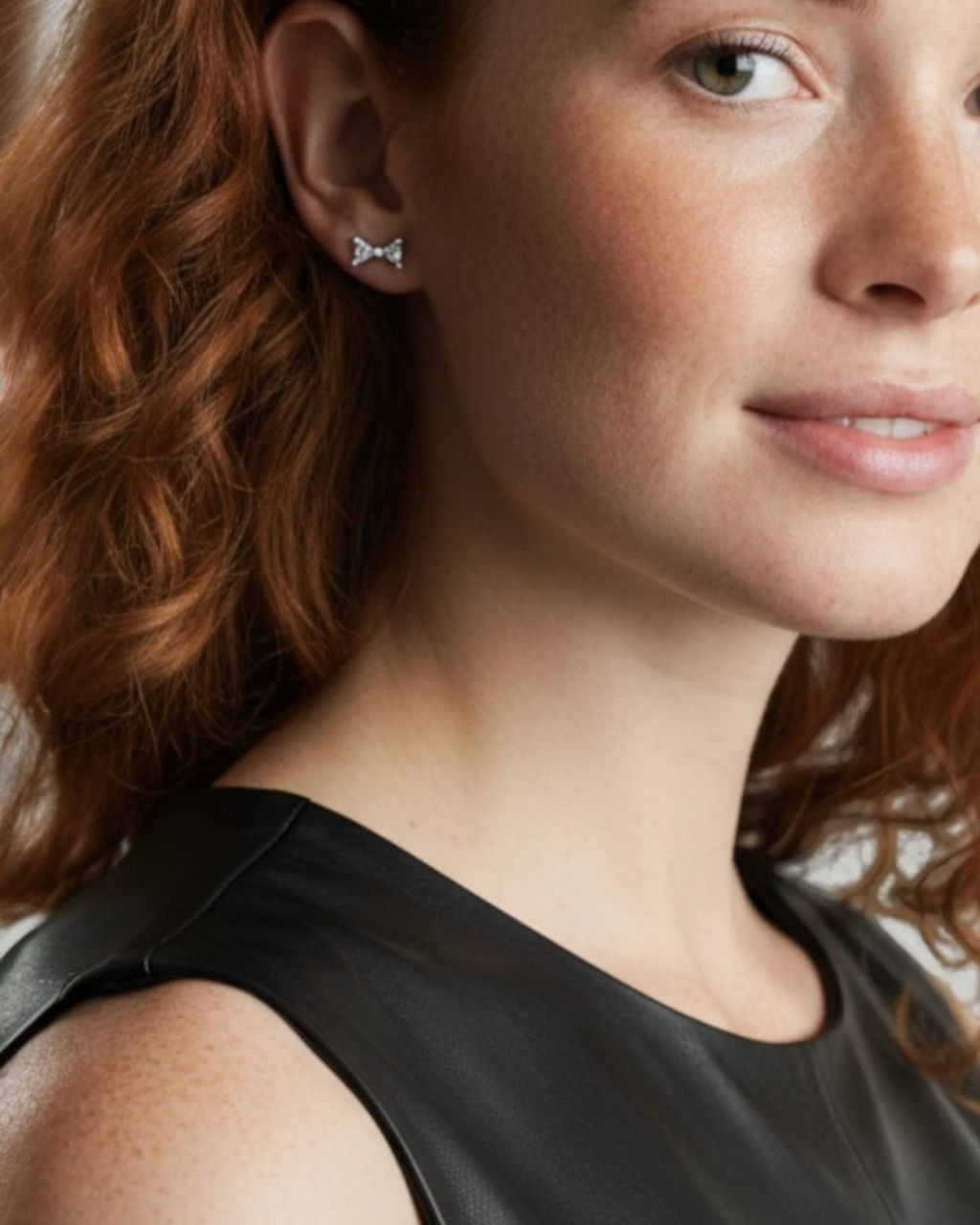 Pearlystones small sterling silver bow stud earrings with white gold plating, perfect for everyday wear.