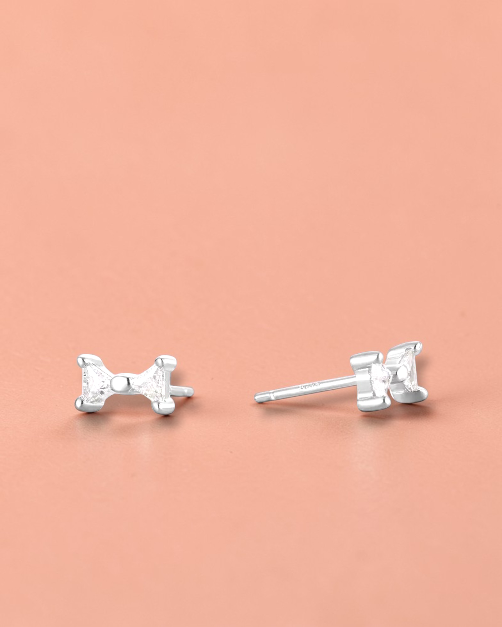 Pearlystones small sterling silver bow stud earrings with white gold plating and cubic zirconia.