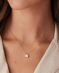 Pearlystones square zircon pendant necklace on a delicate gold chain worn by a woman for a minimalist everyday look.