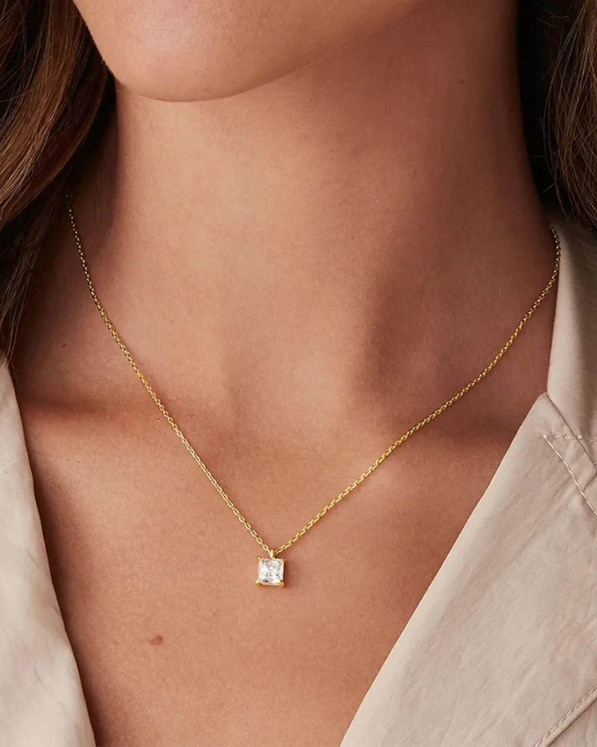 Pearlystones square zircon pendant necklace on a delicate gold chain worn by a woman for a minimalist everyday look.