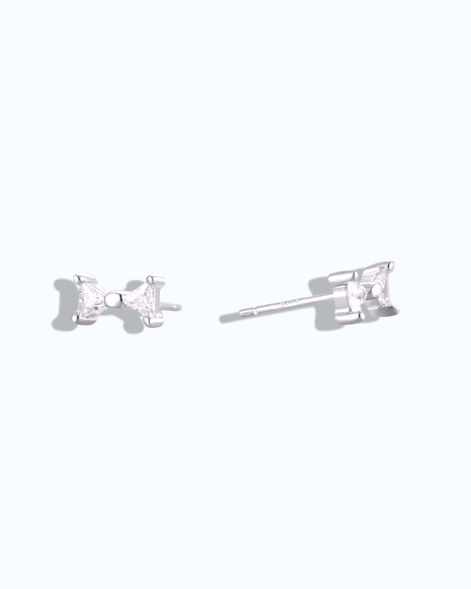 Pearlystones sterling silver bow stud earrings with white gold plating and clear cubic zirconia.
