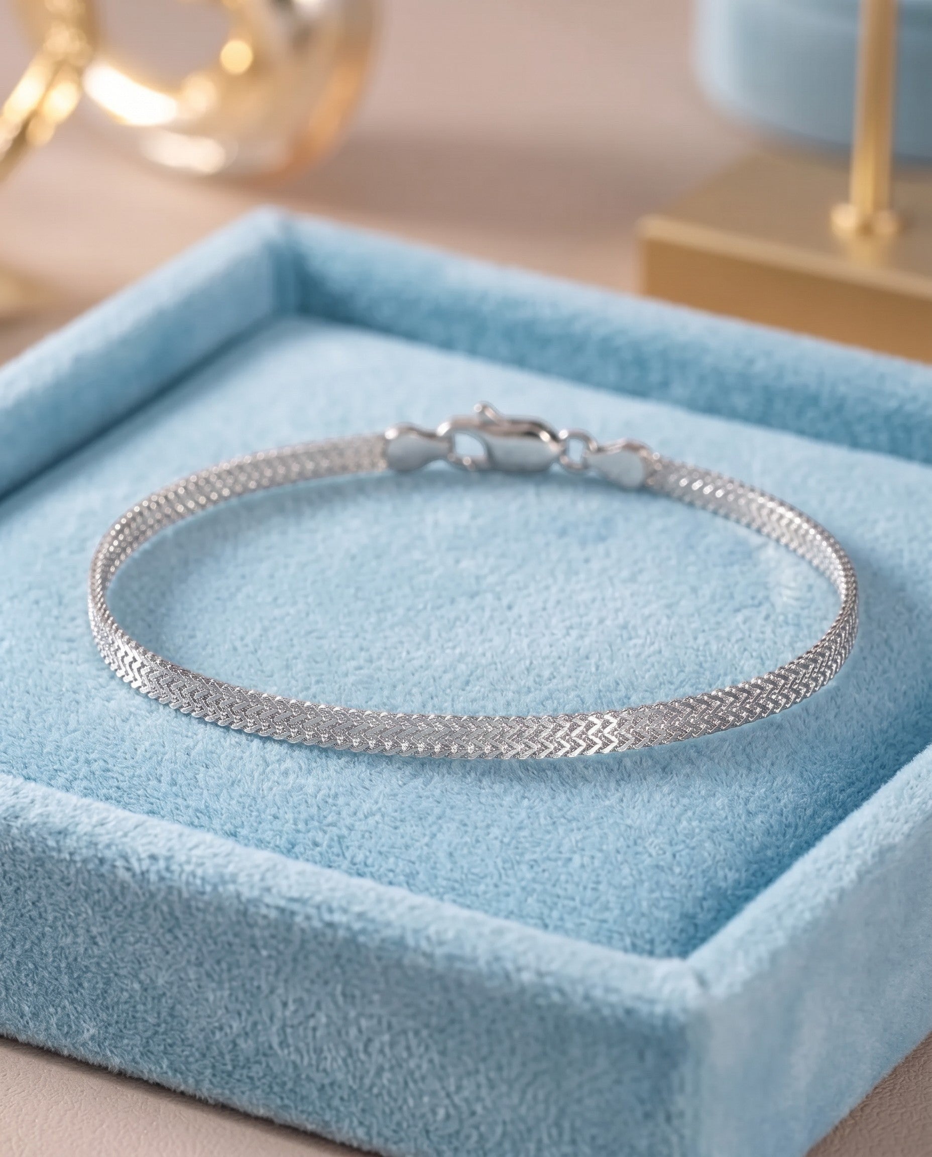 Pearlystones sterling silver double mesh chain bracelet with a polished finish on a blue velvet display tray.