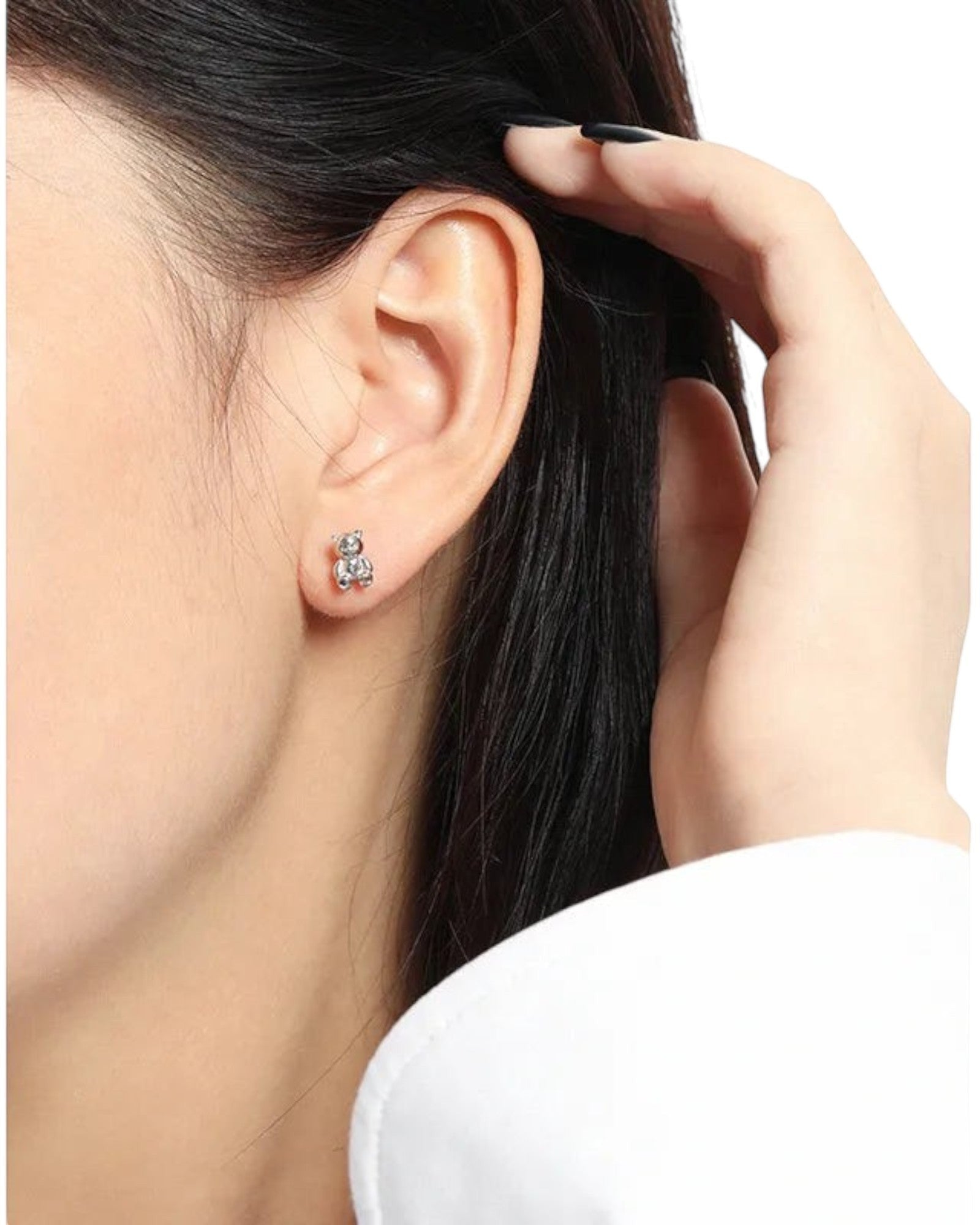 Pearlystones 3D teddy bear stud earrings in polished sterling silver worn on a model's earlobe