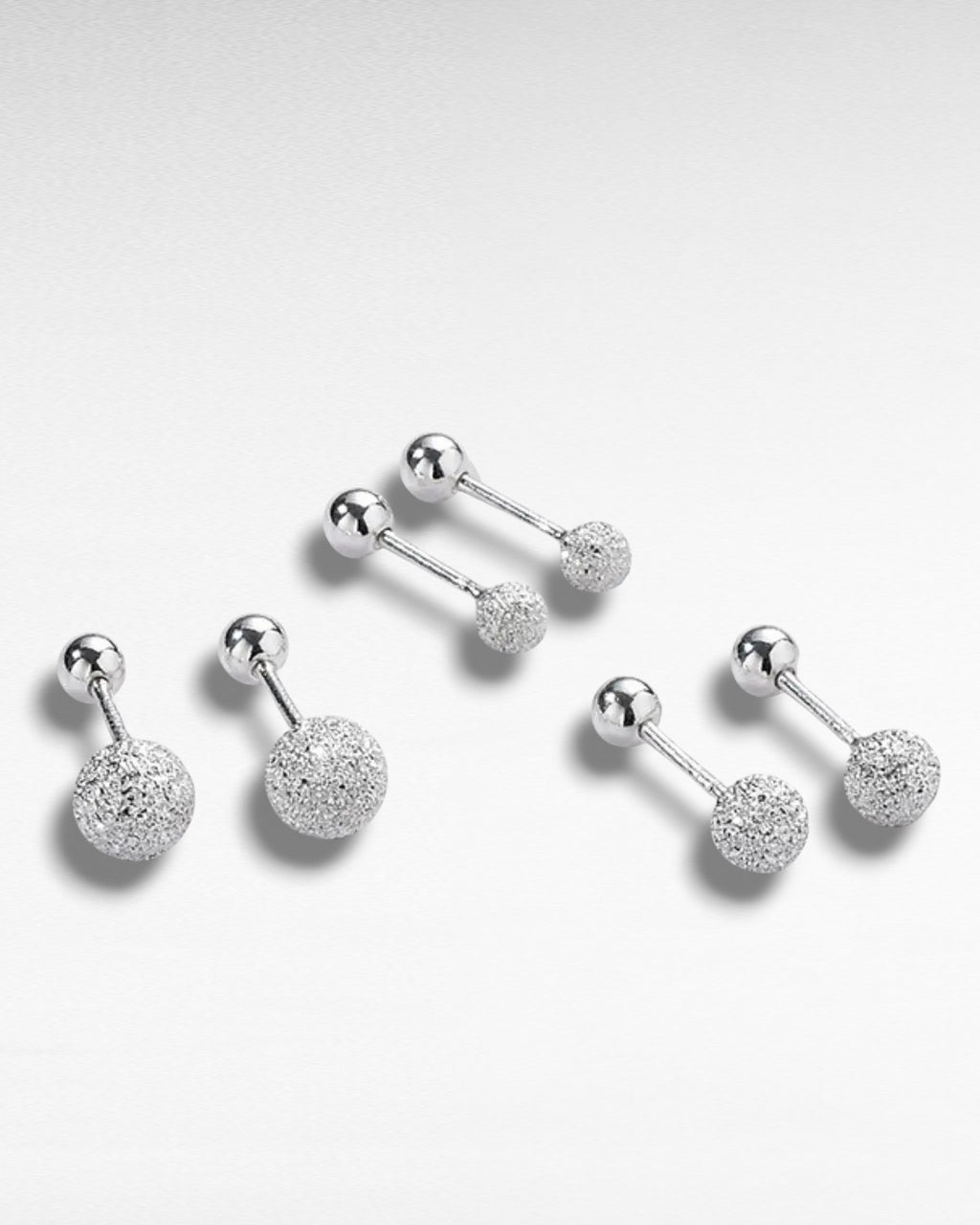 Pearlystones silver textured ball stud earrings with frosted finish and ball back closure.