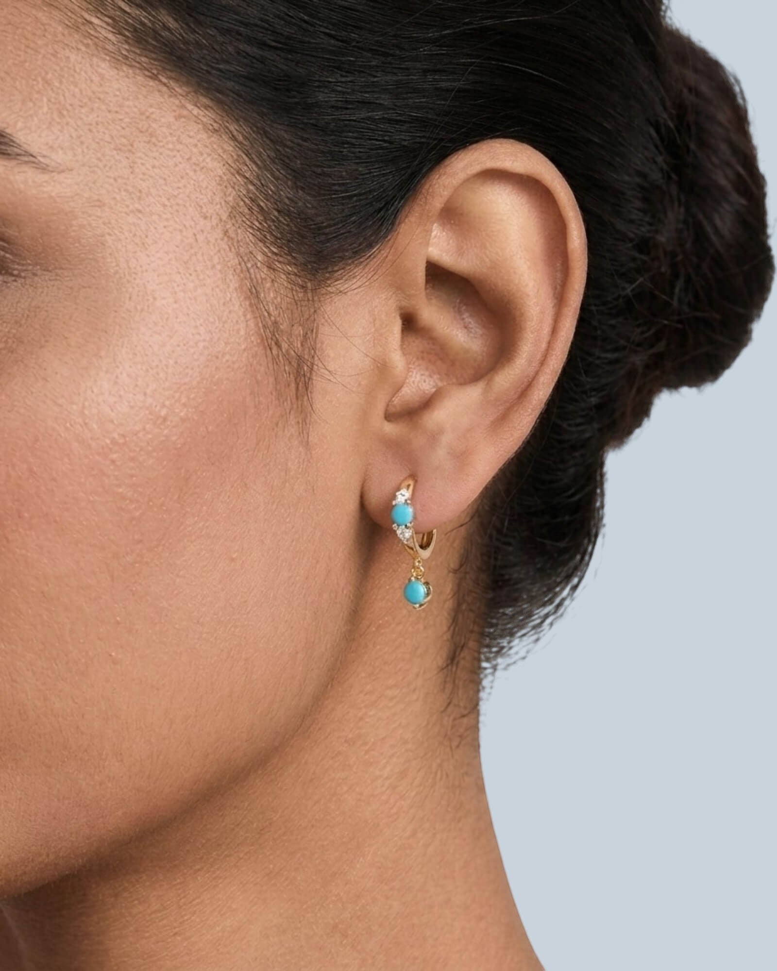 Pearlystones turquoise drop hoop earrings with cubic zirconia accents on sterling silver.
