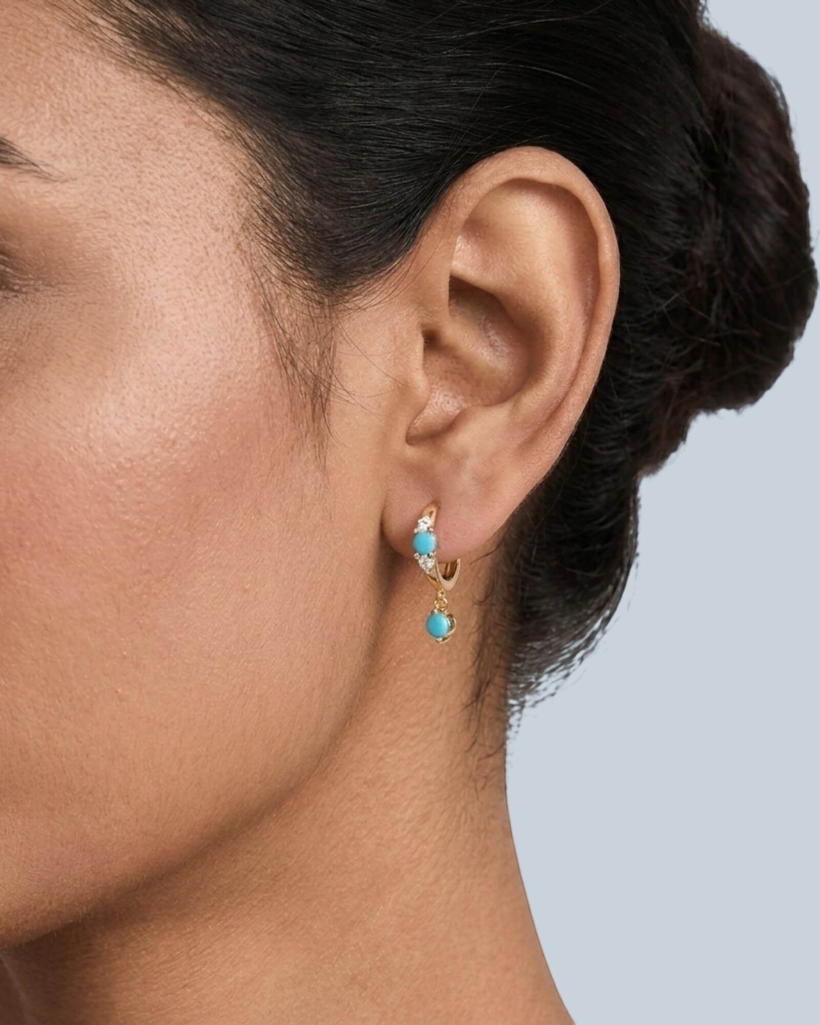 Pearlystones turquoise drop hoop earrings with cubic zirconia accents on sterling silver.