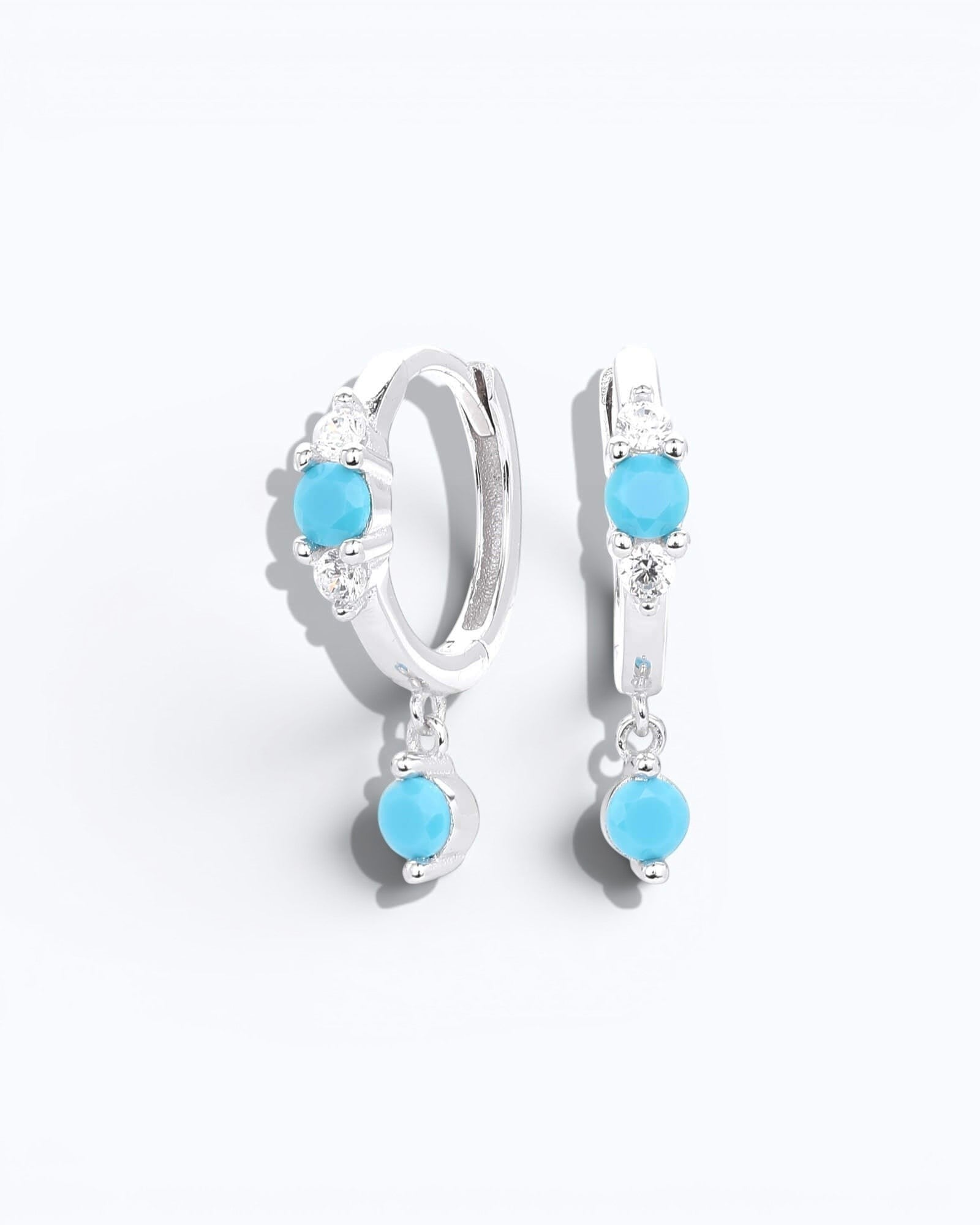 Pearlystones sterling silver hoop earrings with dangling turquoise  coloured stones and cubic zirconia accents.