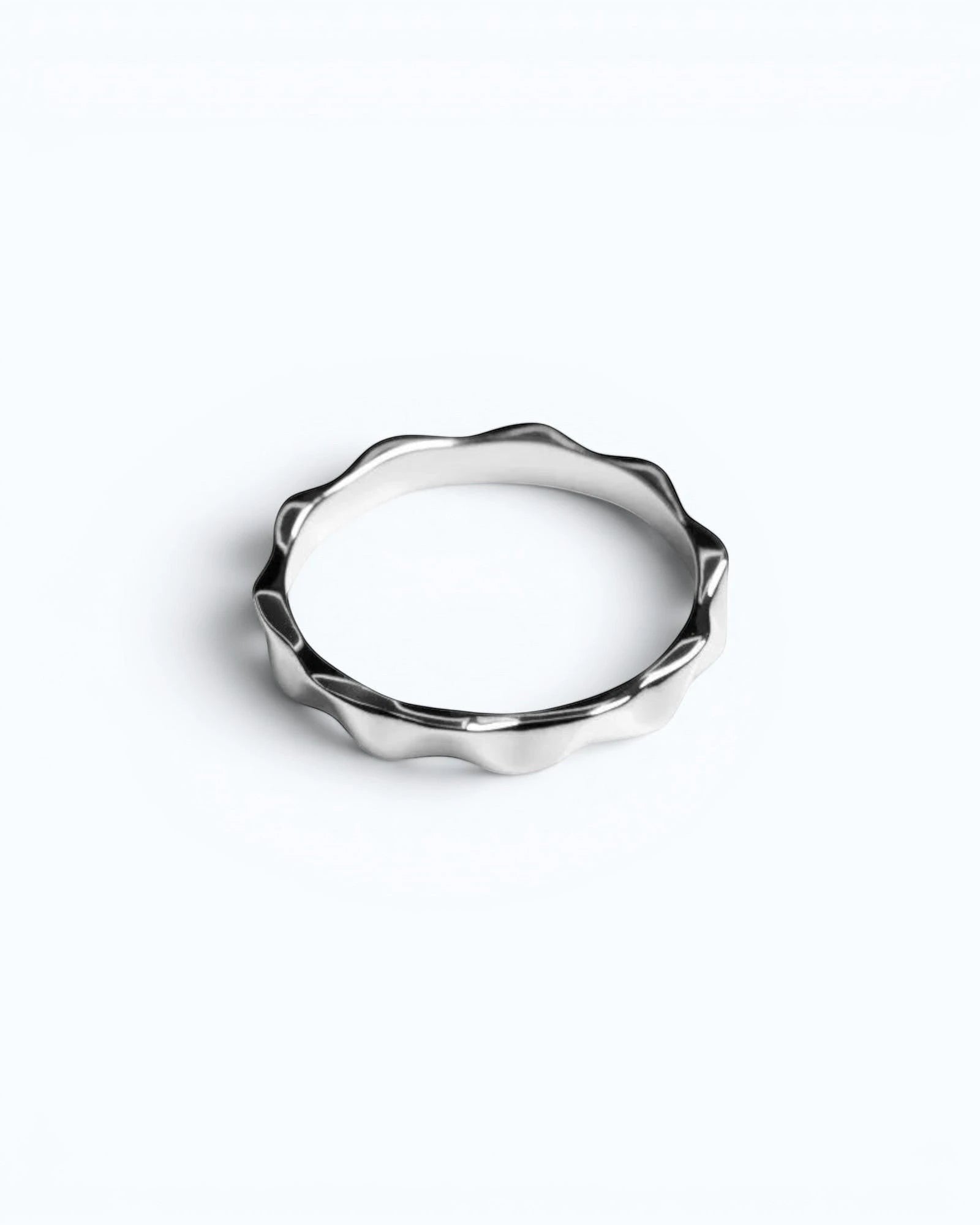 Pearlystones silver wavy band ring with geometric facets, a modern statement piece.